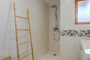 a shower with a wooden ladder in a bathroom at Natür'Gîte in Fellering +18 photos