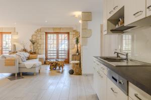 a kitchen with a sink and a living room at Natür'Gîte in Fellering