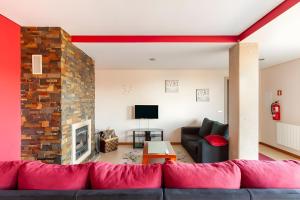 a living room with a couch and a fireplace at Casa de Balinhas - Gerês in Ventosa