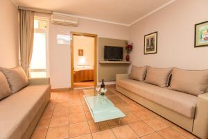 a living room with two couches and a coffee table at Apartments Sofija in Budva