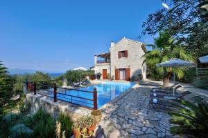 a villa with a swimming pool and a house at Villa Casa Bianca Blue Apartment in Gaios