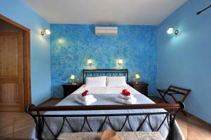 a bedroom with a bed with towels on it at Villa Casa Bianca Blue Apartment in Gaios +35 photos