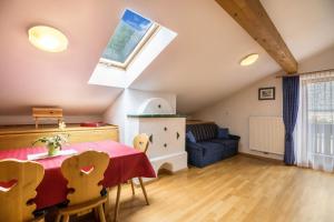 a living room with a table and a couch at Apartment Arnika - Mesnerhof in Sand in Taufers