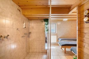 a bathroom with a shower and two beds at Ferienhaus Werdenfels in Mittenwald +145 photos