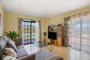 a living room with a couch and a tv at Villa Tazana in Icod de los Vinos