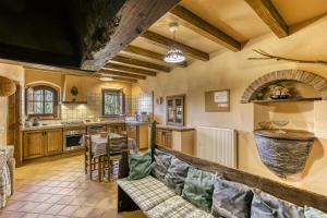 a large kitchen with a couch and a table at Can Palau in Agullana