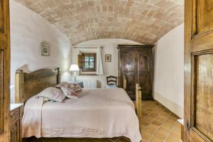 a bedroom with a large bed with a stone ceiling at Can Palau in Agullana +34 photos