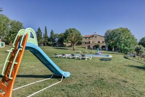 a playground with a blue slide and a pool at Can Palau in Agullana