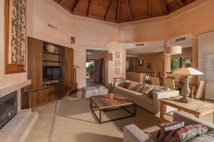 a living room with a couch and a fireplace at Luxury Villa Malva in Benalup Casas Viejas