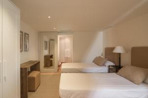 a hotel room with two beds and a mirror at Luxury Villa Malva in Benalup Casas Viejas +31 photos