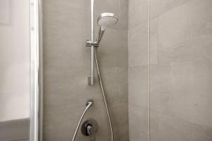 a shower with a shower head in a bathroom at Via Colombo 12 - Trilocale in Bonassola +35 photos