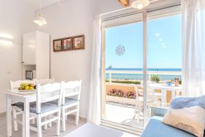 a living room with a view of the ocean at Sunrise Medes in Torroella de Montgrí