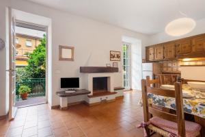a living room with a television and a fireplace at Via Colombo 12 - Trilocale in Bonassola