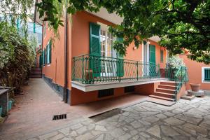 a building with green shutters and a balcony at Via Colombo 12 - Trilocale in Bonassola