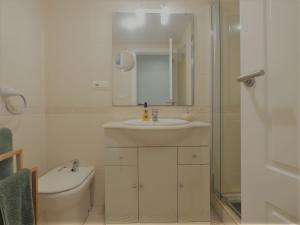 a bathroom with a sink and a toilet and a shower at Ático en Jávea - Solo Familias 1813 in Platja de l'Arenal +11 photos
