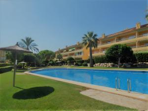 a large swimming pool in front of a building at Ático en Jávea - Solo Familias 1813 in Platja de l'Arenal