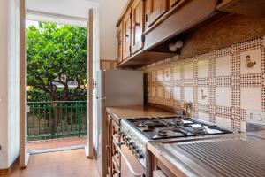a kitchen with a stove top oven next to a window at Via Colombo 12 - Trilocale in Bonassola