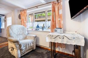 a living room with a chair and a window at Deichkate Deichwinkel in Drochtersen