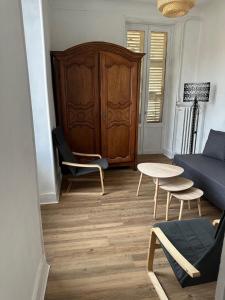 a living room with a couch and a table at Appartement 16 colette in La Bourboule