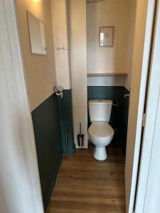 a small bathroom with a toilet in a room at Appartement 16 colette in La Bourboule +18 photos
