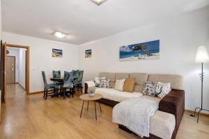 a living room with a couch and a table at Ria Formosa Pool Heaven in Olhão