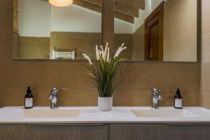 a bathroom with two sinks and a mirror at Son Pons in Llucmajor +37 photos