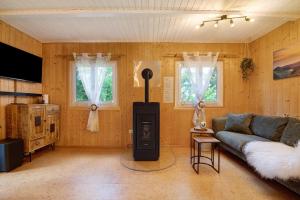 a living room with a couch and a stove in it at Sonnenpark 44 in Roding