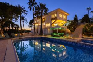a large swimming pool in front of a house at Urban Elegance by Fidalsa in Alicante