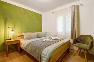 a bedroom with a bed with a green wall at Sonnenpark 44 in Roding