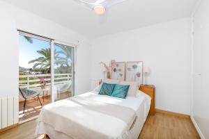 a white bedroom with a bed and a large window at Urban Elegance by Fidalsa in Alicante +25 photos