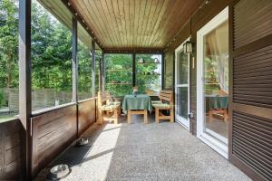 a screened porch of a house with a table and chairs at Sonnenpark 44 in Roding