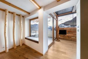 a room with a large window and a television at Naturoase Stegerhof Apt Ringelblume in Trodena