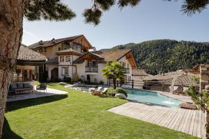 an exterior view of a house with a swimming pool at Naturoase Stegerhof Apt Ringelblume in Trodena