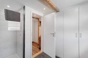 a bathroom with white walls and a shower at Erlebnis-Bauernhof Scheunenglück in Oberkirch +28 photos