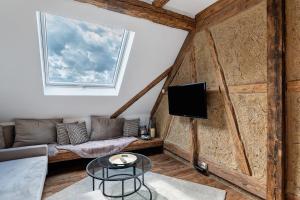 a living room with a couch and a tv at Erlebnis-Bauernhof Scheunenglück in Oberkirch