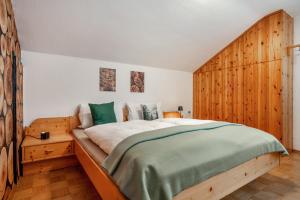 a bedroom with a large bed with a wooden headboard at Ferienwohnung Carlina in Pfronten