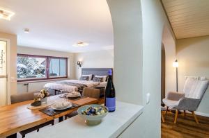 a living room and dining room with a bed and a table at Ferienwohnung Behling in Frickingen