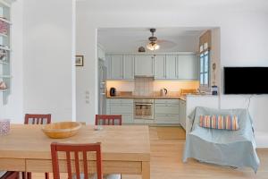 a kitchen and dining room with a wooden table at Efrossyni House in Ioulis
