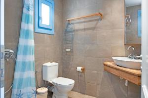 a bathroom with a toilet and a sink at Efrossyni House in Ioulis +21 photos