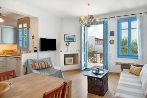 a living room with a couch and a table at Efrossyni House in Ioulis