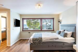 a bedroom with a large bed with a window at Ferienwohnung Behling in Frickingen
