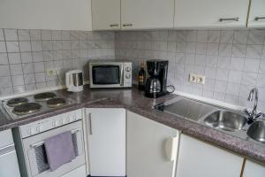 a kitchen with a sink and a microwave at Ferienwohnung Roth in Frickingen