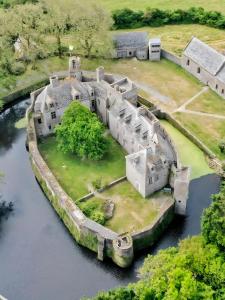 an old castle in the middle of a river at Maison De Plage Le Cocon Pirouais in Pirou