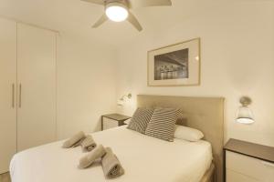a bedroom with two beds and a ceiling fan at Apartamento Yumbo Maspalomas in Maspalomas +16 photos
