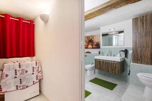 a bathroom with a toilet and a sink at Nel Cuore della Via Francigena in Aosta +26 photos