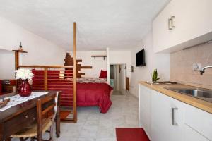 a kitchen with a sink and a bed in a room at Nel Cuore della Via Francigena in Aosta
