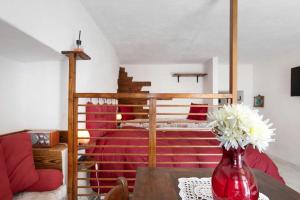 a bedroom with a bed and a vase with flowers on a table at Nel Cuore della Via Francigena in Aosta