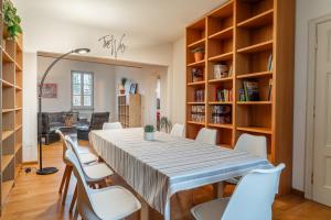 a dining room with a table and chairs at Chica's Lucca Luxury Loft in Lucca