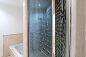 a shower with a glass door in a bathroom at Chica's Lucca Luxury Loft in Lucca +22 photos