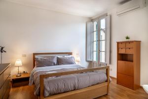 a bedroom with a bed and a window at Chica's Lucca Luxury Loft in Lucca